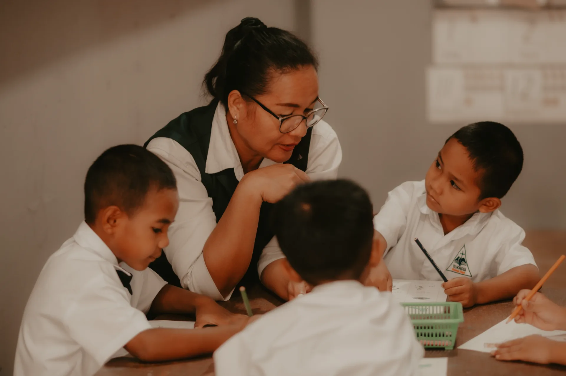 A teacher working closely with a student
